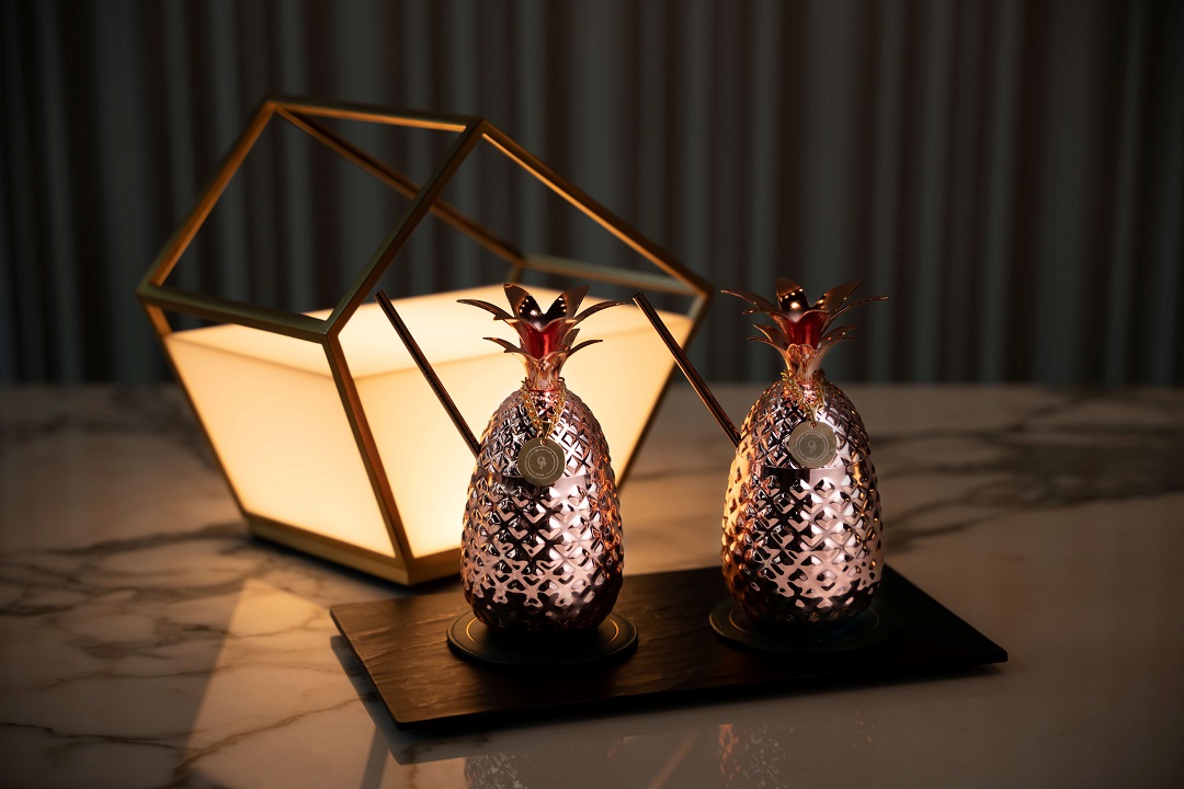 Welcome drinks at The Outpost Hotel Sentosa are served in pineapple-shaped copper vessels.